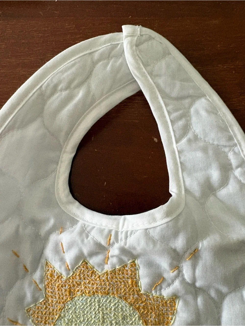 Hand embroidered sun quilted baby bib